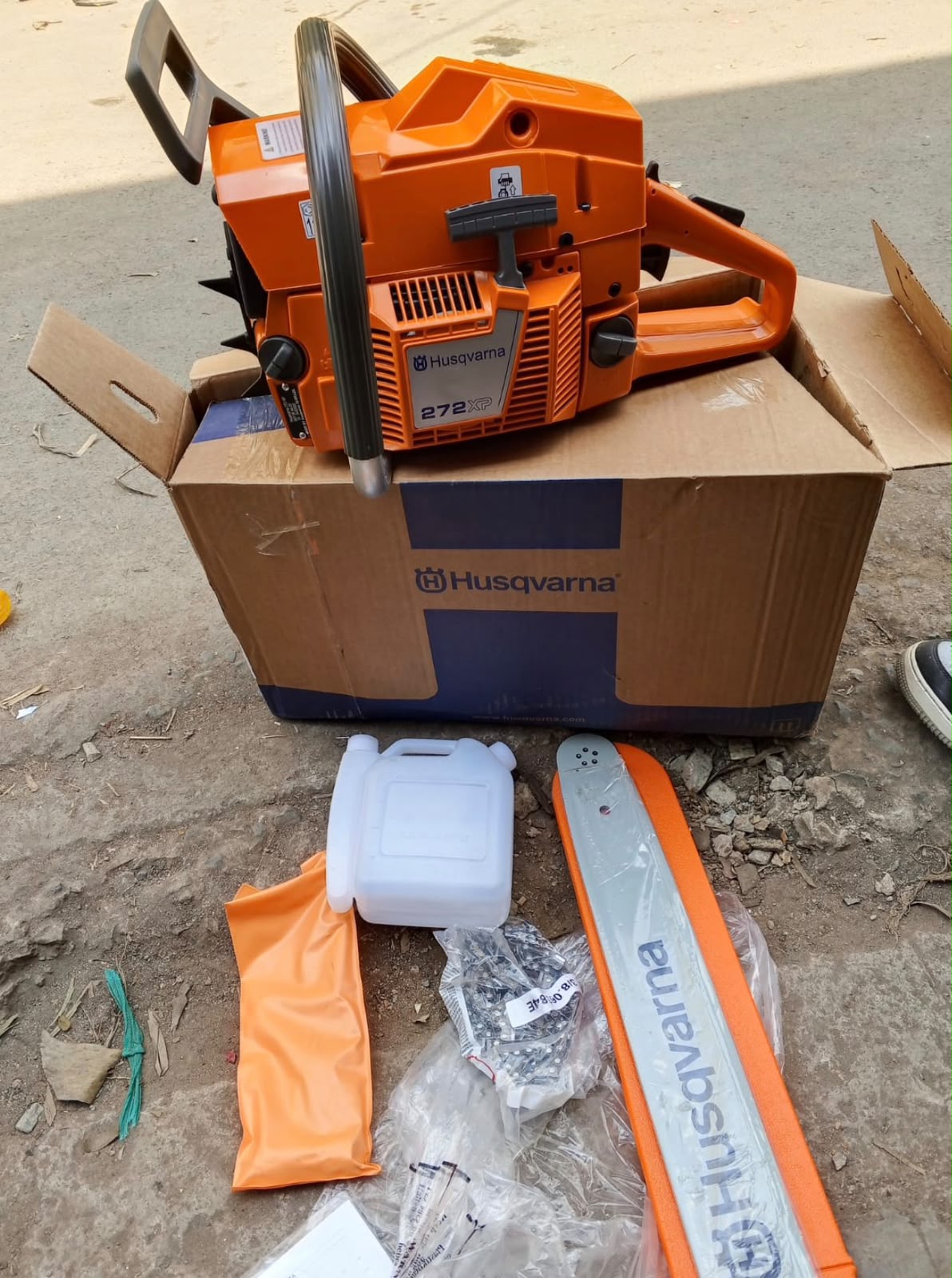 Seller photo of the Husqvarna 272XP chainsaw and supplied accessories