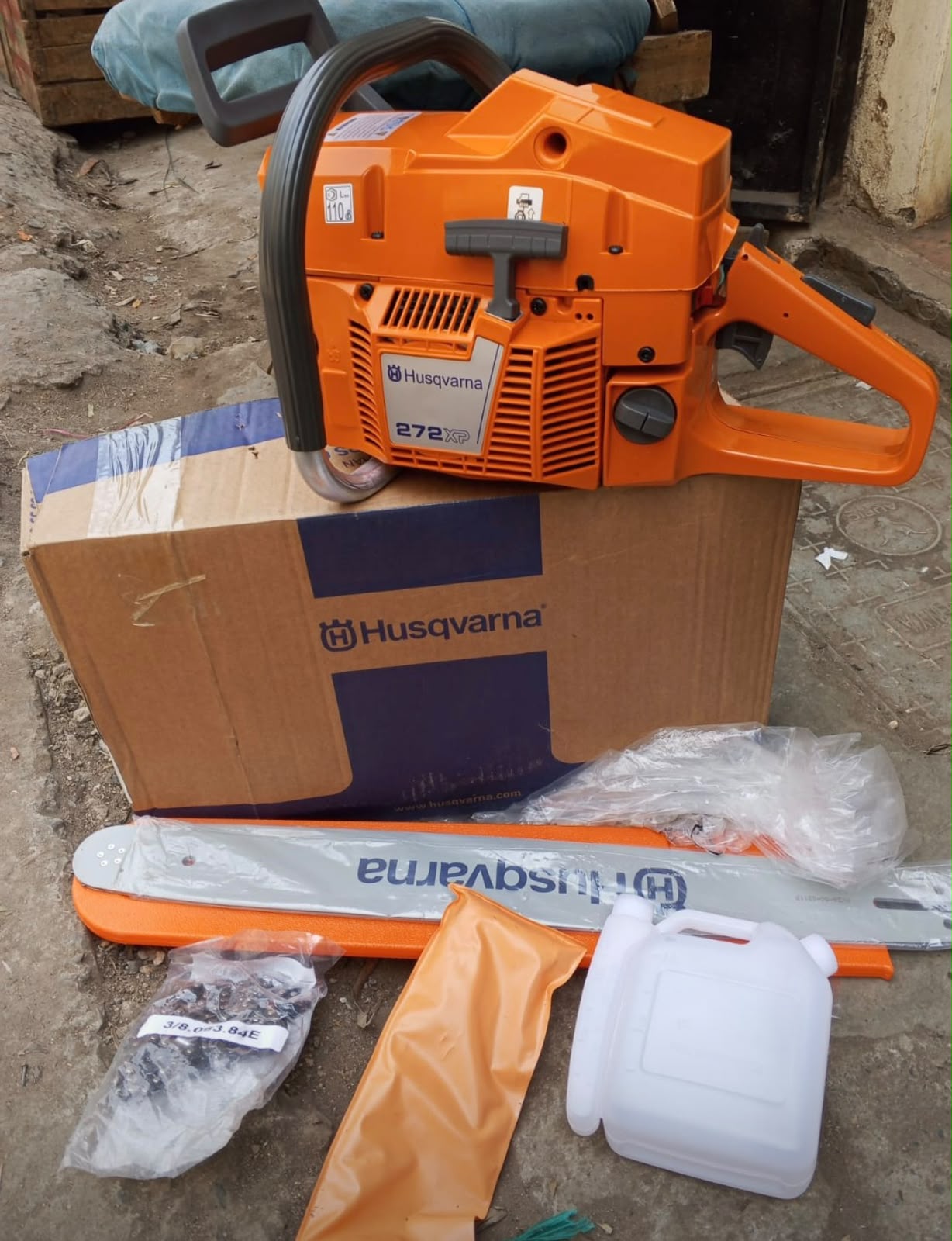 Seller photo of the Husqvarna 272XP chainsaw and accessories